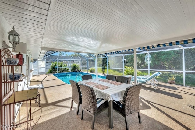 exterior space featuring glass enclosure, a patio, and outdoor dining area