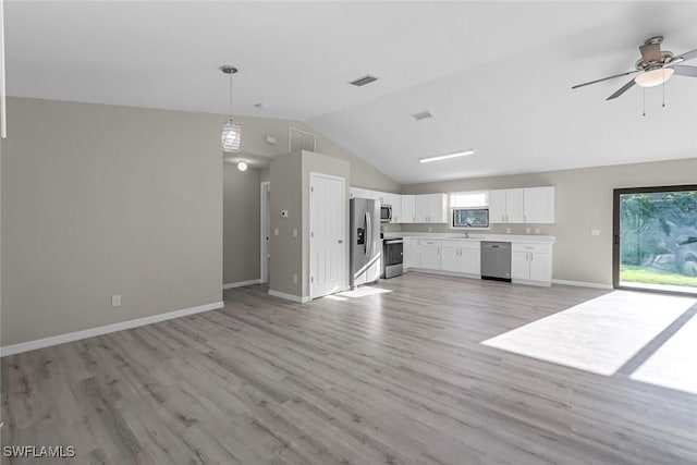 unfurnished living room featuring visible vents, light wood-style flooring, baseboards, ceiling fan, and vaulted ceiling