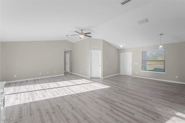 unfurnished living room featuring visible vents, baseboards, wood finished floors, and vaulted ceiling