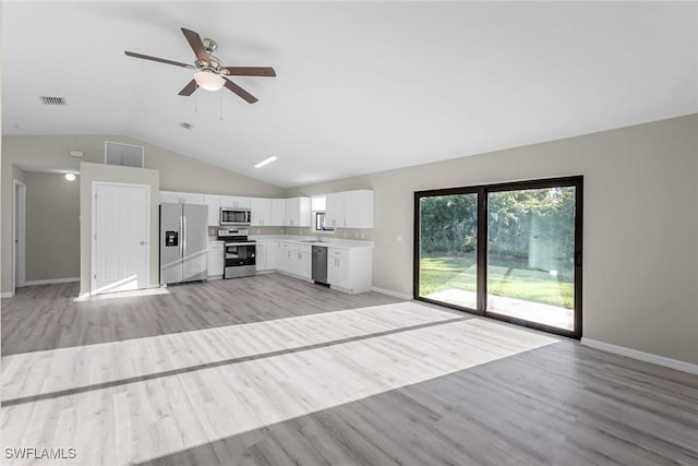 kitchen featuring visible vents, stainless steel appliances, light wood-type flooring, and open floor plan