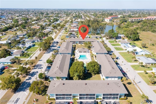 drone / aerial view with a residential view and a water view