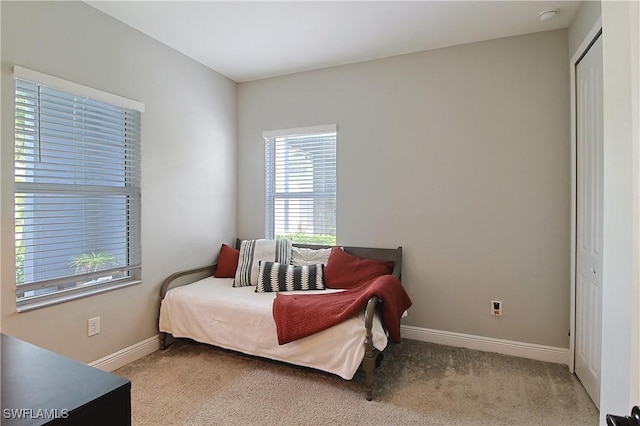 carpeted bedroom featuring baseboards