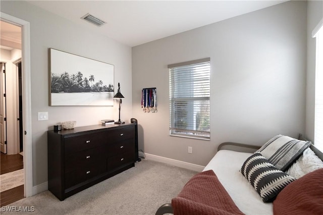 living area featuring light carpet, visible vents, and baseboards