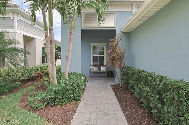 doorway to property with stucco siding