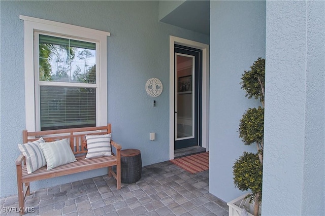 property entrance with stucco siding