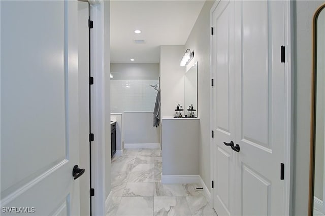 bathroom featuring vanity, baseboards, tiled shower, recessed lighting, and marble finish floor