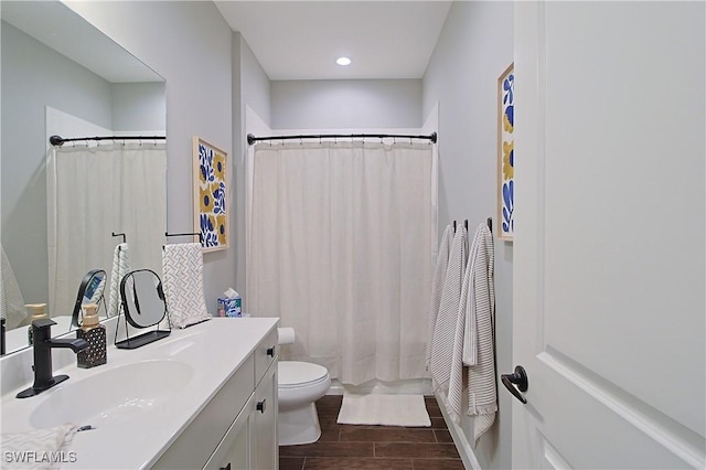 bathroom with vanity, shower / tub combo, toilet, and wood finish floors