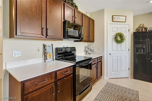 kitchen featuring light tile patterned floors, black appliances, and light countertops