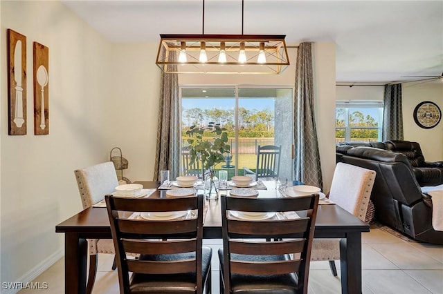 dining room featuring light tile patterned floors and baseboards