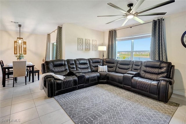 living room with light tile patterned flooring, visible vents, and ceiling fan