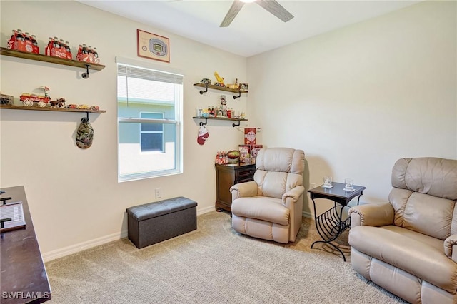 sitting room with carpet flooring, baseboards, and ceiling fan