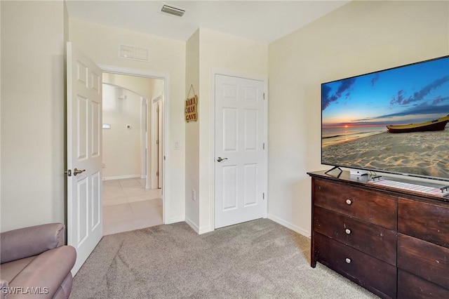 bedroom with visible vents, baseboards, and light colored carpet