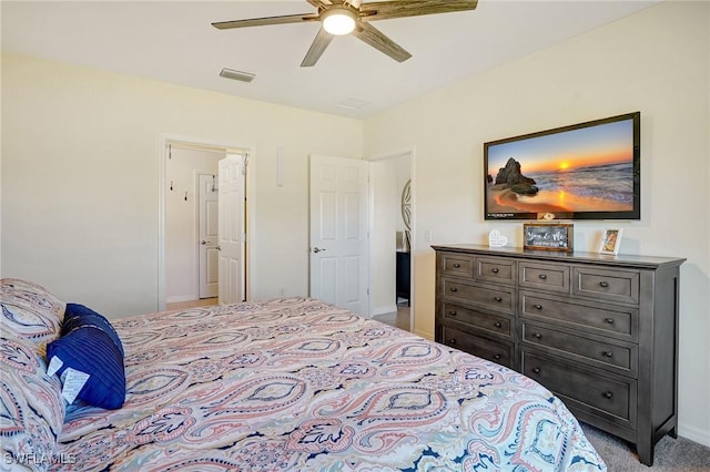 carpeted bedroom with visible vents, baseboards, and ceiling fan