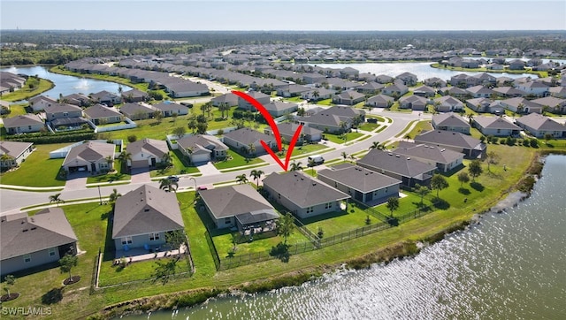 birds eye view of property featuring a residential view and a water view