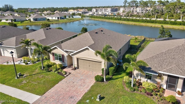 birds eye view of property with a residential view and a water view