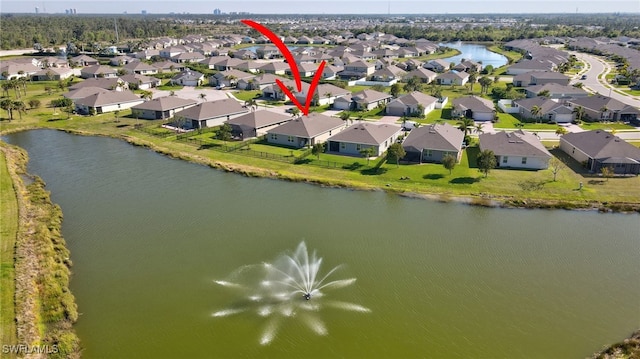 bird's eye view featuring a residential view and a water view