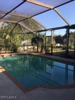 pool featuring a lanai and a patio area