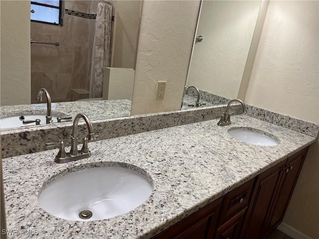 full bath featuring a sink and a textured wall