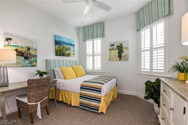 carpeted bedroom with ceiling fan and baseboards