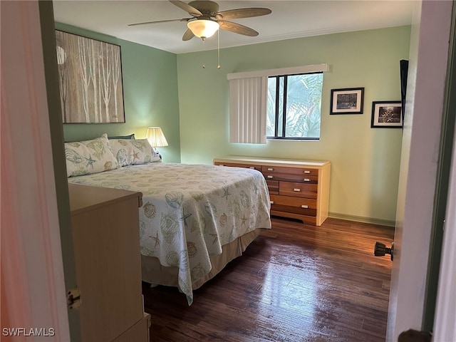 bedroom with ceiling fan, baseboards, and dark wood finished floors