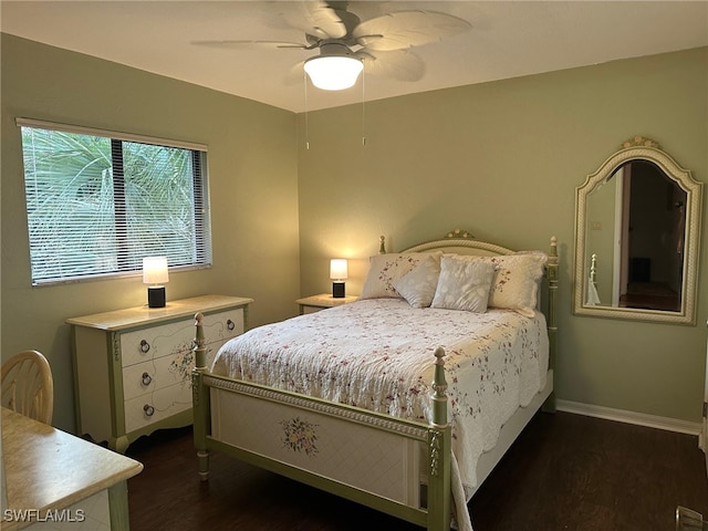 bedroom featuring ceiling fan, dark wood-type flooring, and baseboards