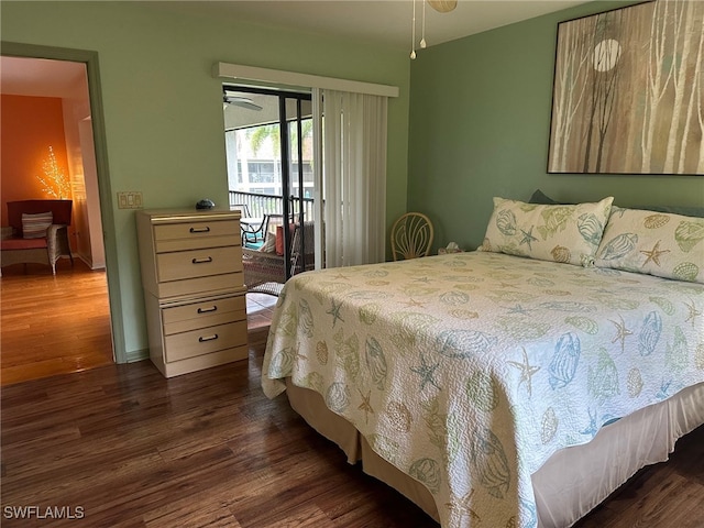 bedroom featuring dark wood finished floors and access to exterior