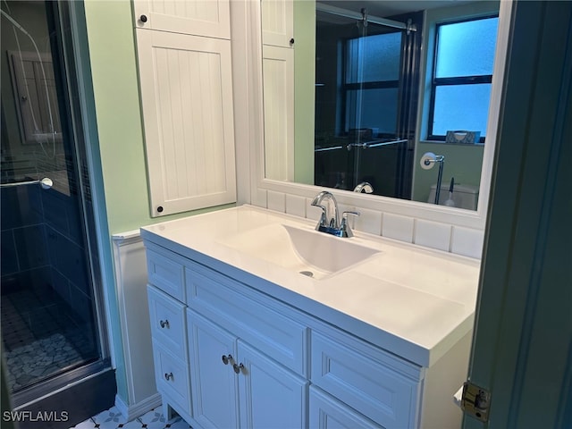 bathroom with vanity and a shower stall