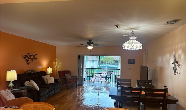 living area with wood finished floors, visible vents, and ceiling fan