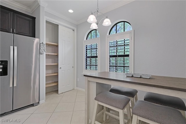 dining area featuring baseboards, ornamental molding, light tile patterned floors, recessed lighting, and a notable chandelier