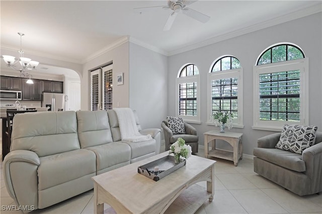 living area featuring crown molding, light tile patterned floors, ceiling fan with notable chandelier, and baseboards