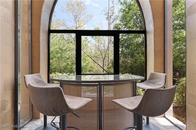 sunroom / solarium featuring a dry bar