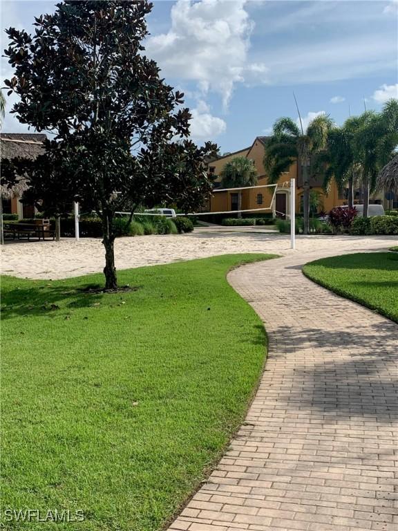 view of home's community with a yard and volleyball court