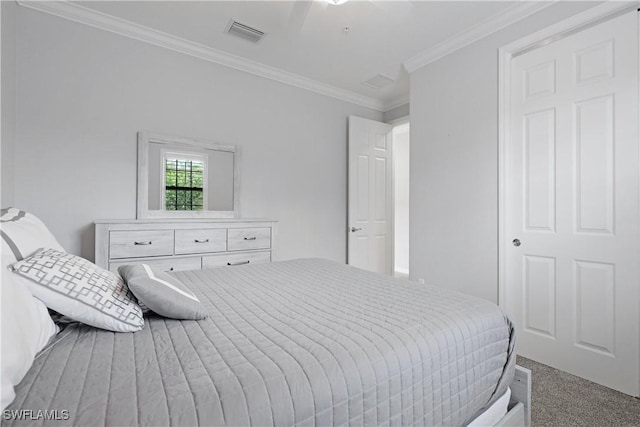 carpeted bedroom featuring ceiling fan, visible vents, and ornamental molding