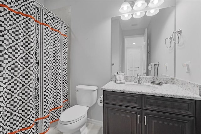 bathroom featuring a tile shower, toilet, and vanity