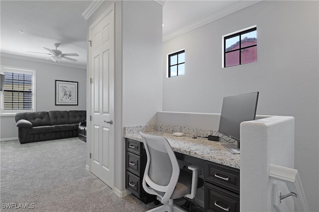 office featuring baseboards, light carpet, ornamental molding, and a ceiling fan