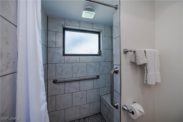 full bath featuring tiled shower