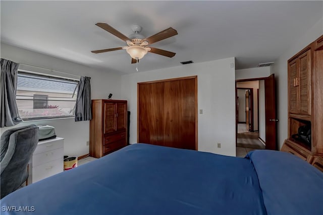 bedroom with a closet, visible vents, and ceiling fan