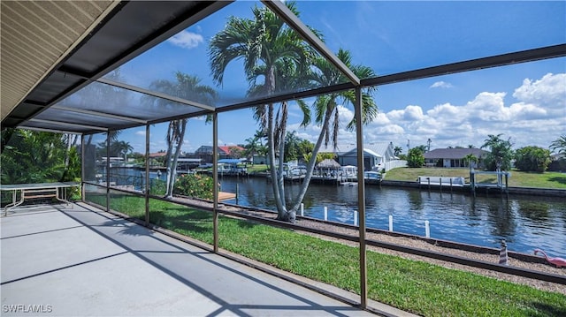 unfurnished sunroom with a water view