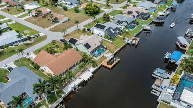 drone / aerial view with a residential view and a water view