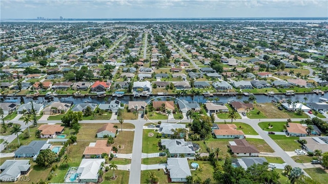 birds eye view of property featuring a residential view and a water view