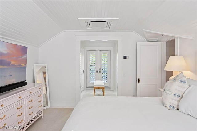 bedroom with visible vents, lofted ceiling, baseboards, and access to outside