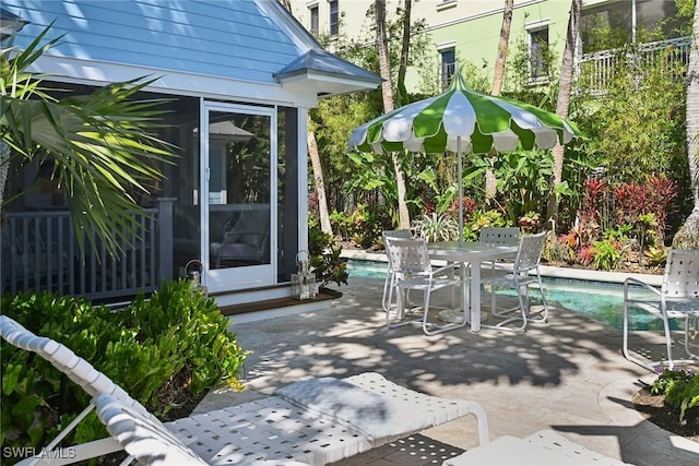 view of patio with outdoor dining space and an outdoor pool