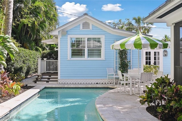 outdoor pool with a patio area