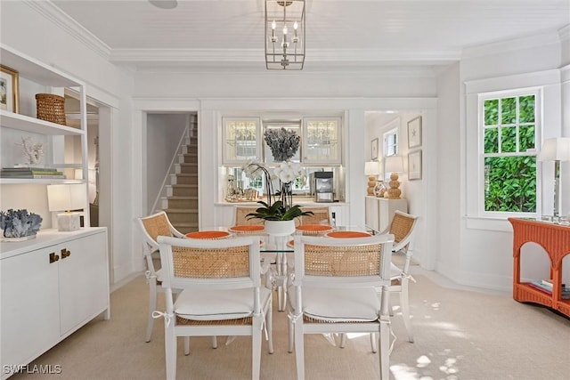 dining room featuring light colored carpet, stairs, crown molding, and baseboards