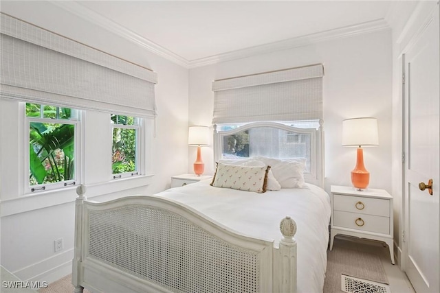 bedroom featuring baseboards and crown molding