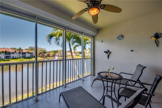 sunroom / solarium featuring a water view