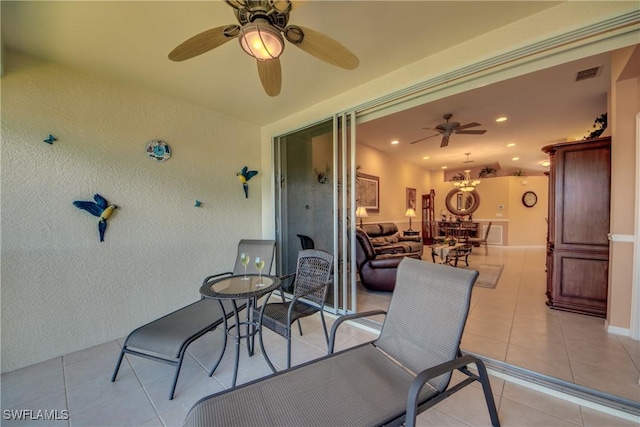 view of patio / terrace featuring a ceiling fan and visible vents