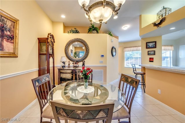 dining space featuring light tile patterned floors and baseboards