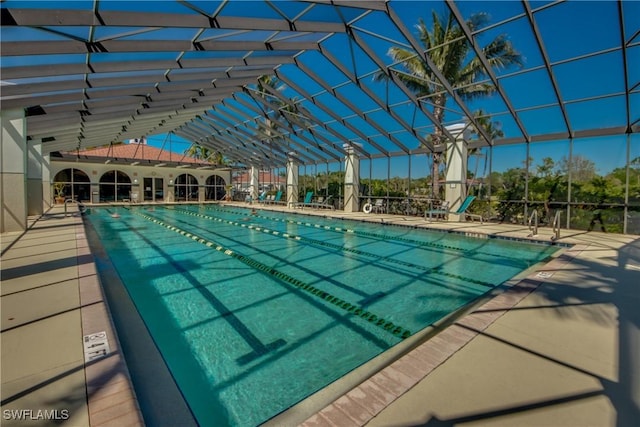 community pool with a patio area and a lanai