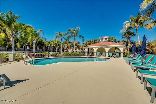 community pool featuring a patio and fence